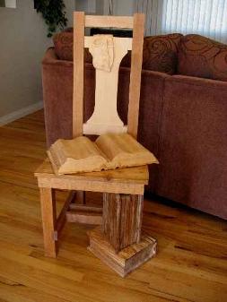 carved books and reading glasses on chair with book legs