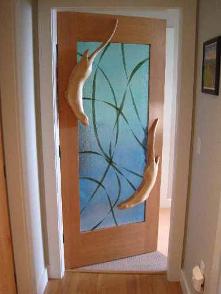 Carved Door with otters swiming in kelp glass